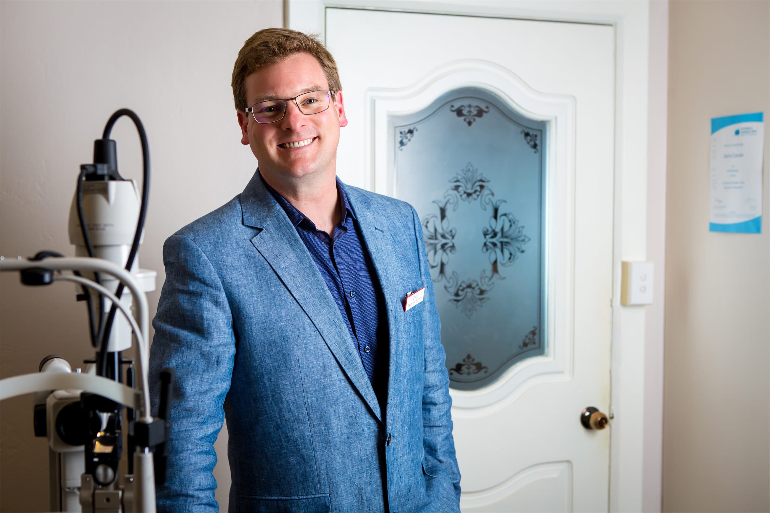 Ashburton Eyecare optometrist standing in a consulting room