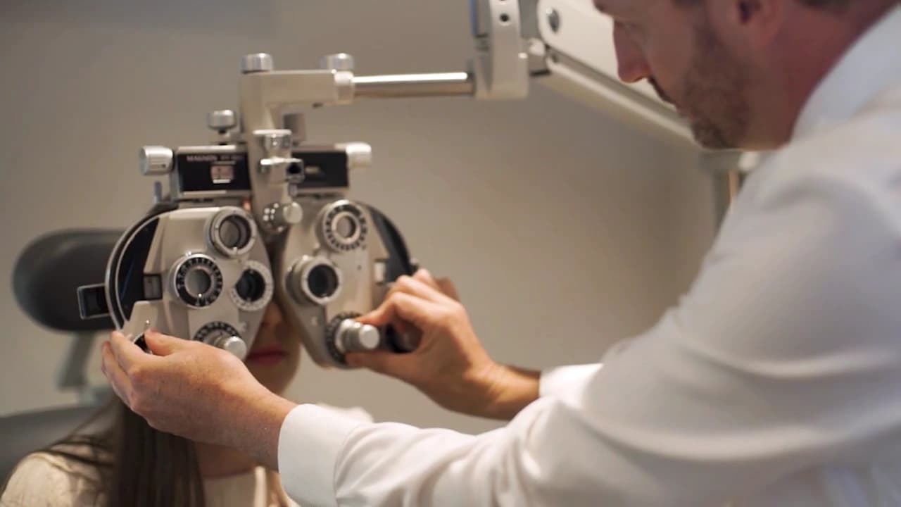 Graham Hill Eyecare optometrist using eye-testing equipment during an exam.