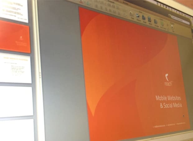 A laptop displaying a Reach Digital presentation titled Mobile Websites and Social Media